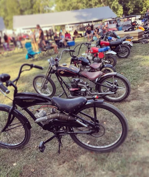 A row of custom mini bikes and bicycles on display at the bike show